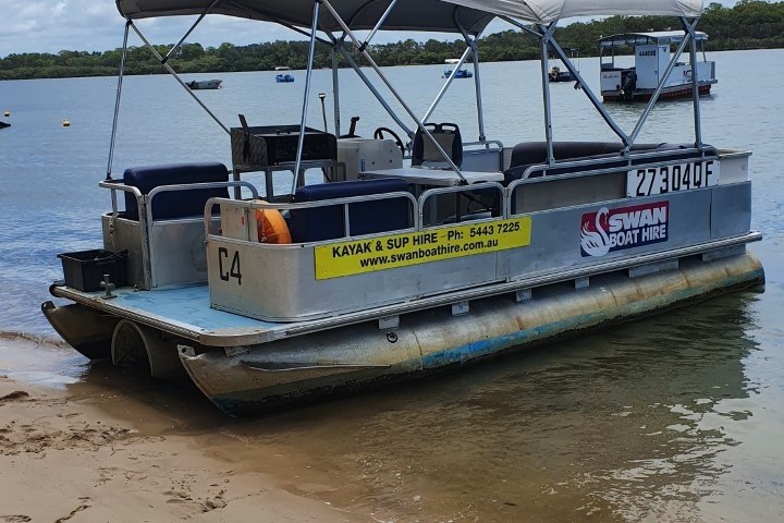 a boat sitting on top of a sandy beach