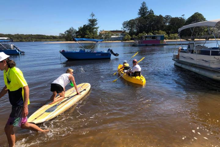 a group of people in a small boat in a body of water