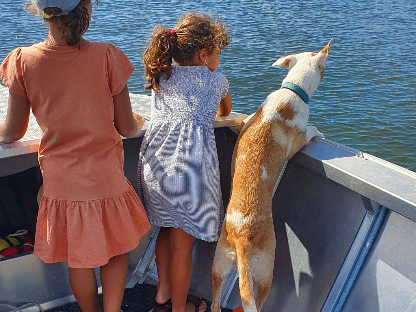 a woman sitting next to a body of water
