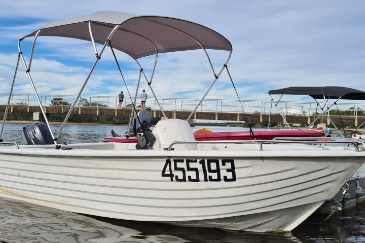 a boat is docked next to a body of water