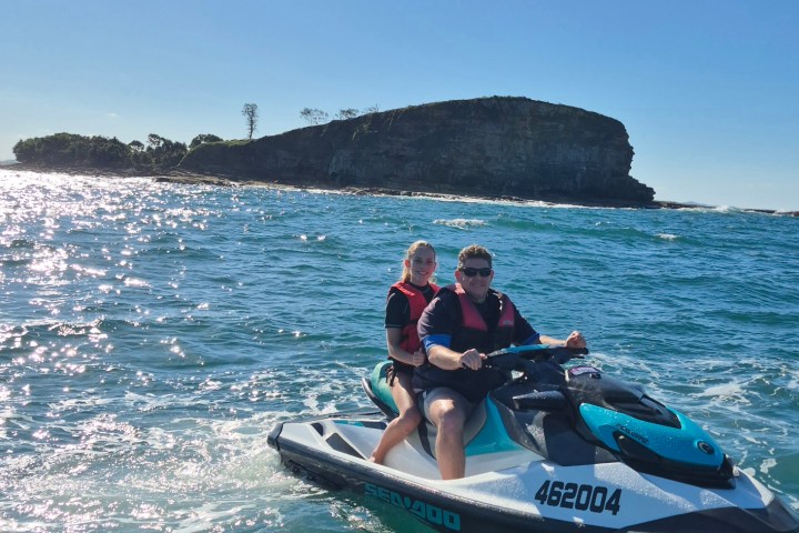 Two people on a jet ski Ocean Tour in front of Mudjimba island off the Sunshine Coast.