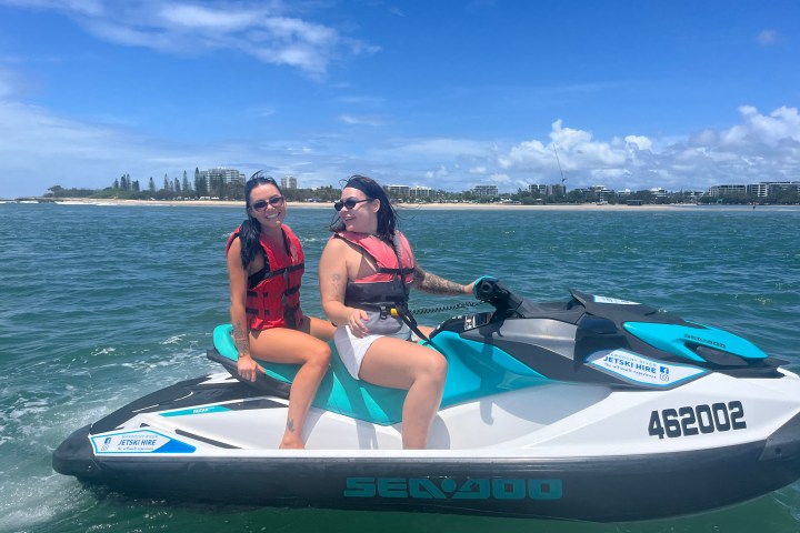 a person riding on the back of a boat in the water
